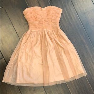 strapless cocktail dress on a light coral color